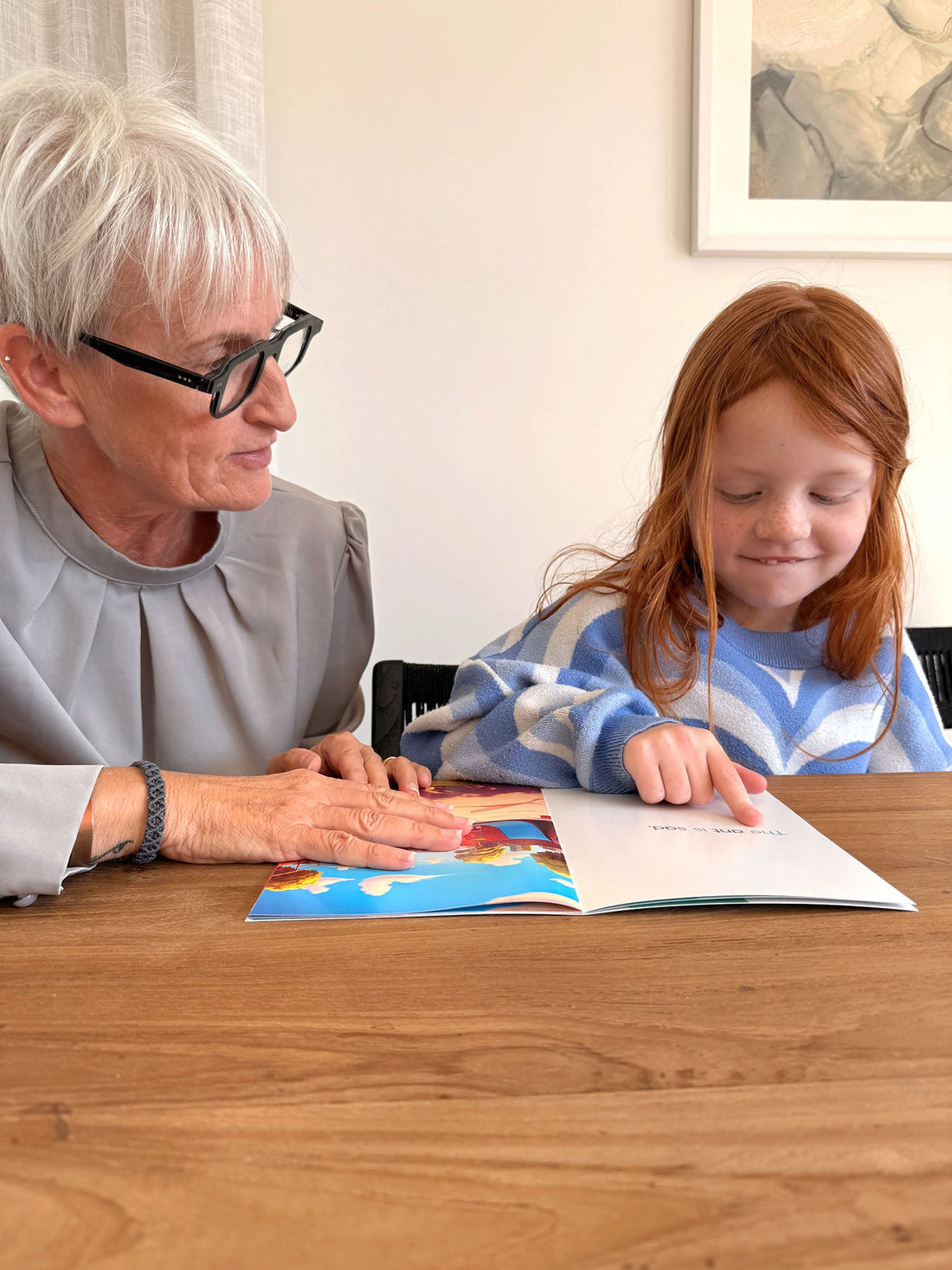 Ali Fullick reading an Innerlinks decodable book with a young ginger-haired girl during a structured literacy session
