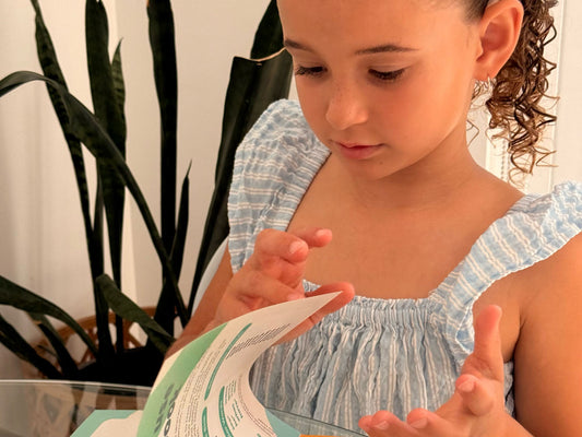 Close up of a girl reading an Innerlinks decodable book during a structured literacy session