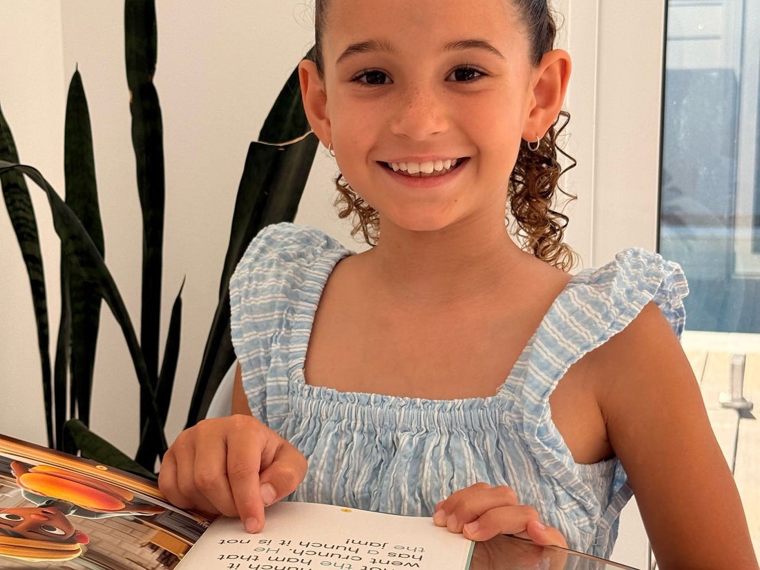 A reader pointing at text in an Innerlinks decodable book