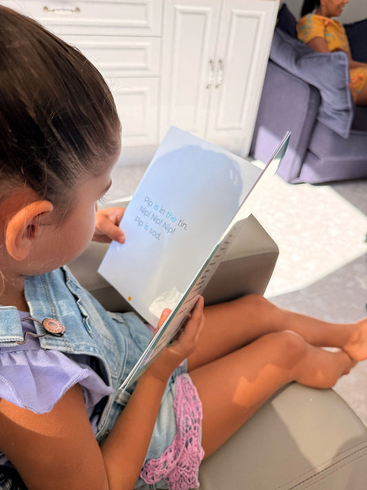 A young girl reading an Innerlinks decodable book independently